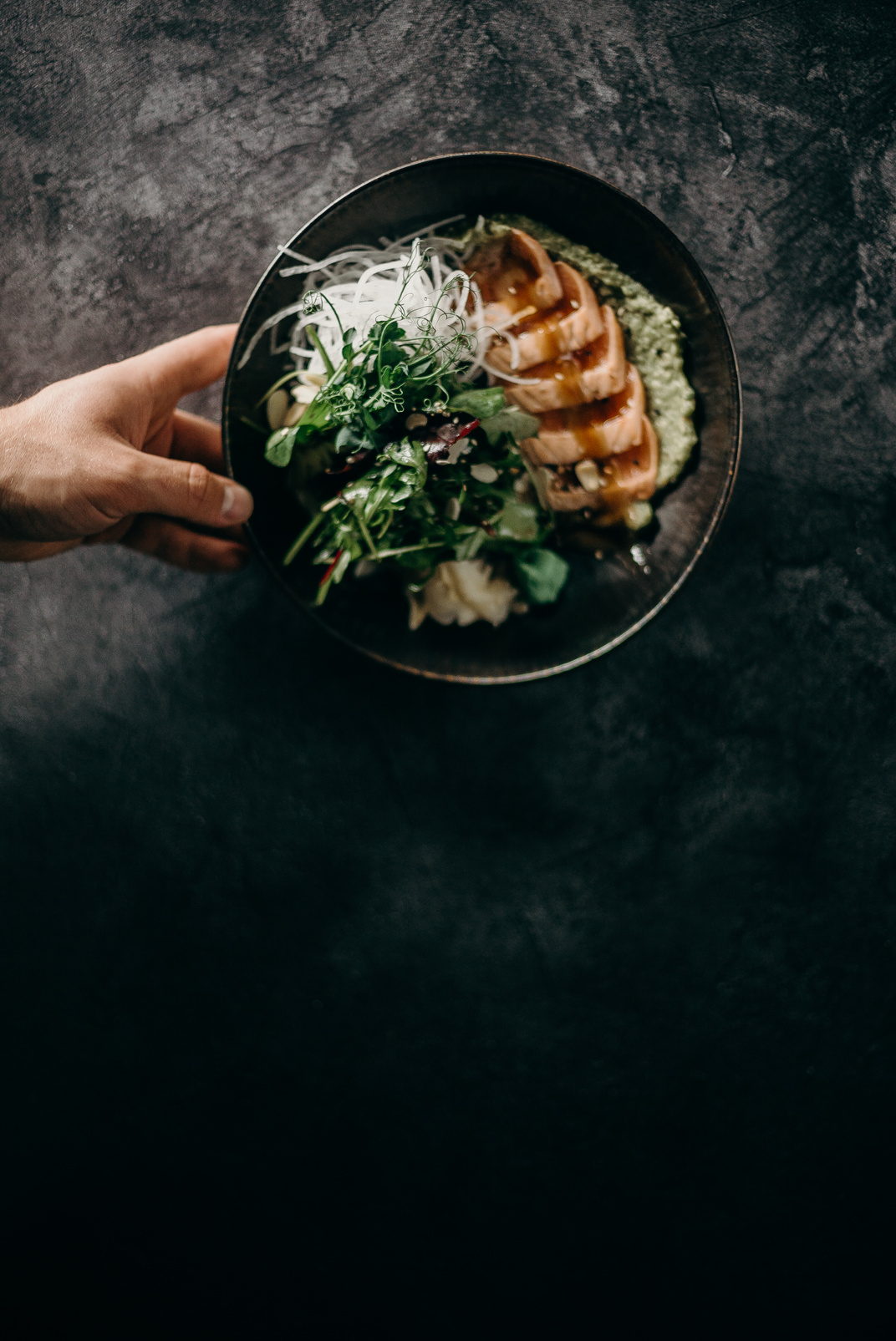 Person Holding Black Ceramic Bowl With Food